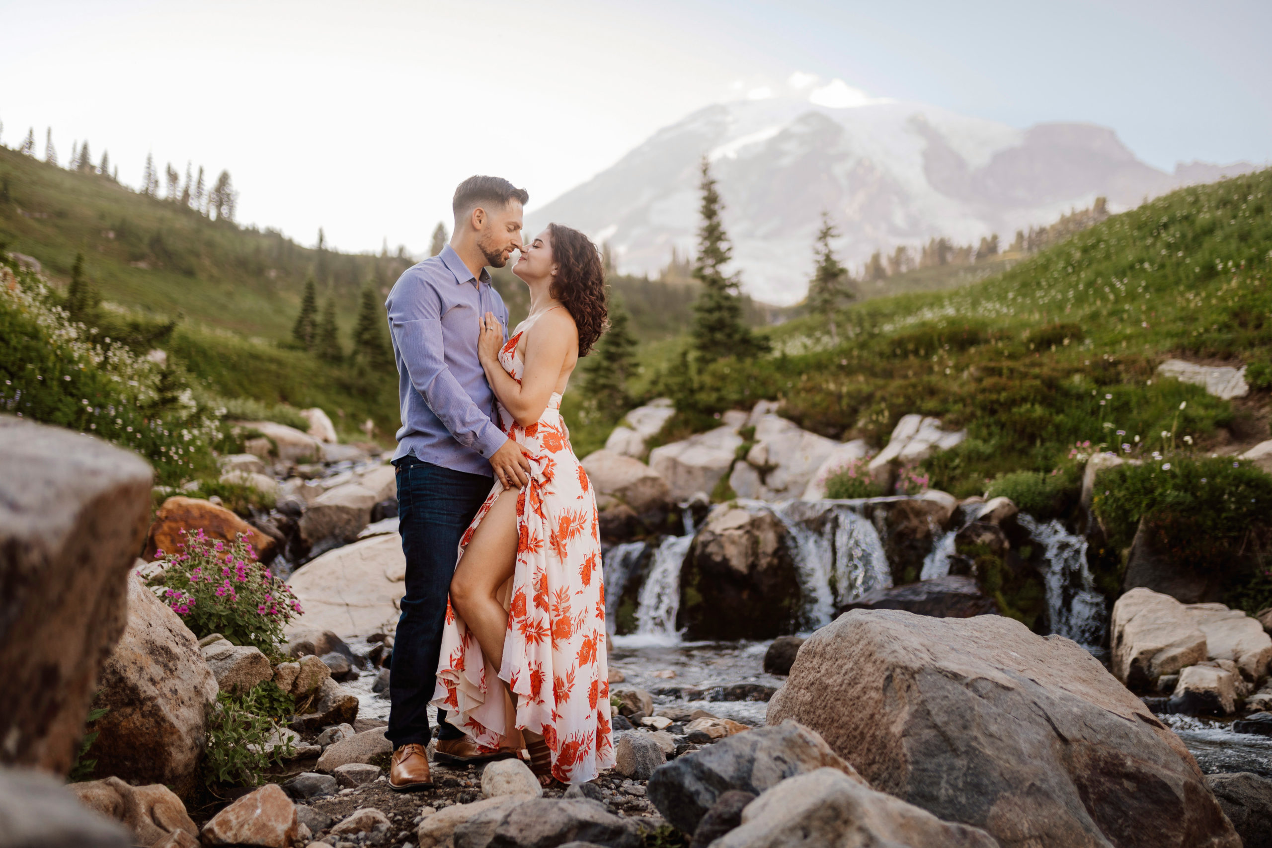 Couple embracing in front of Mt. Rainier.