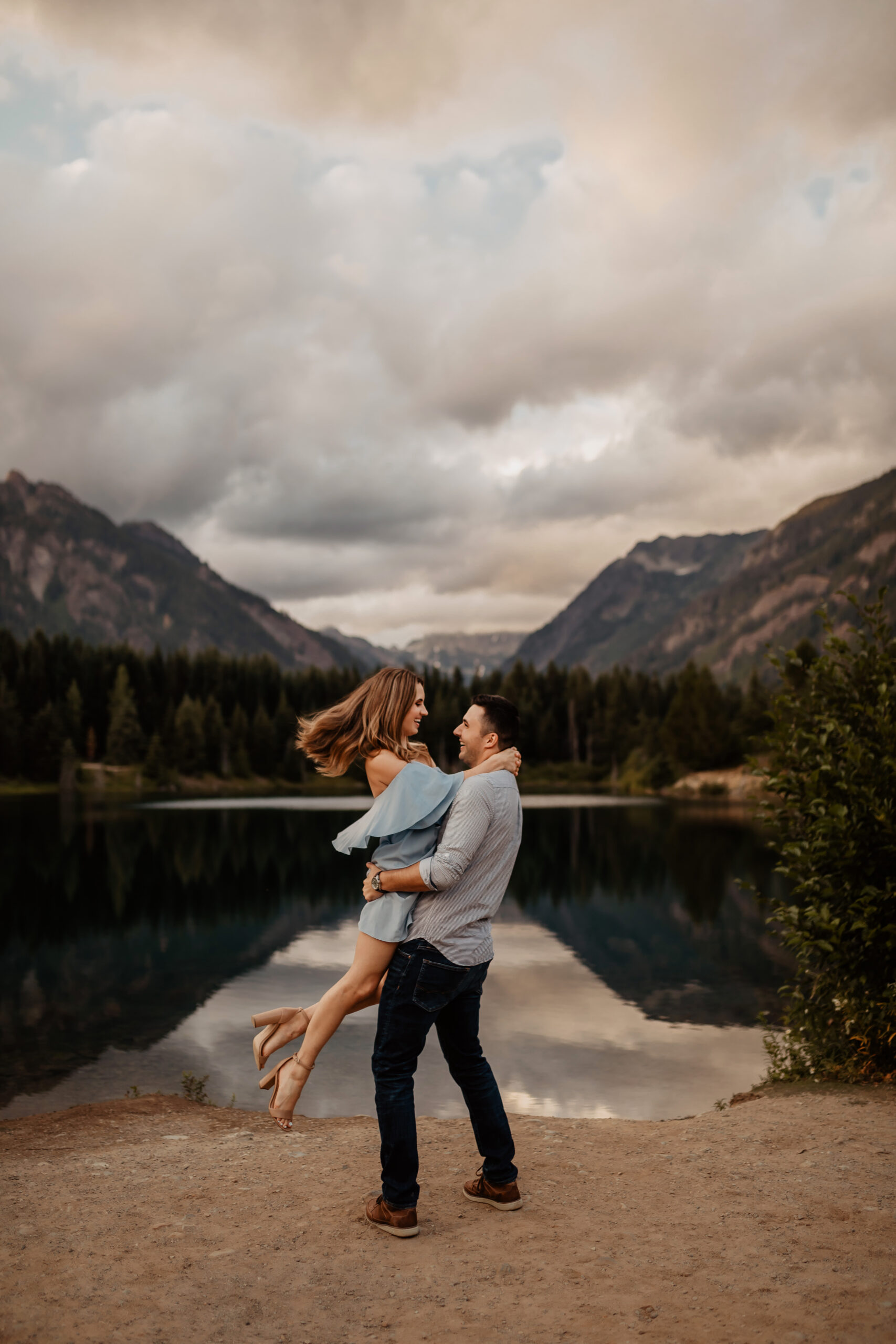 Man twirls woman in front of Gold Creek Pond