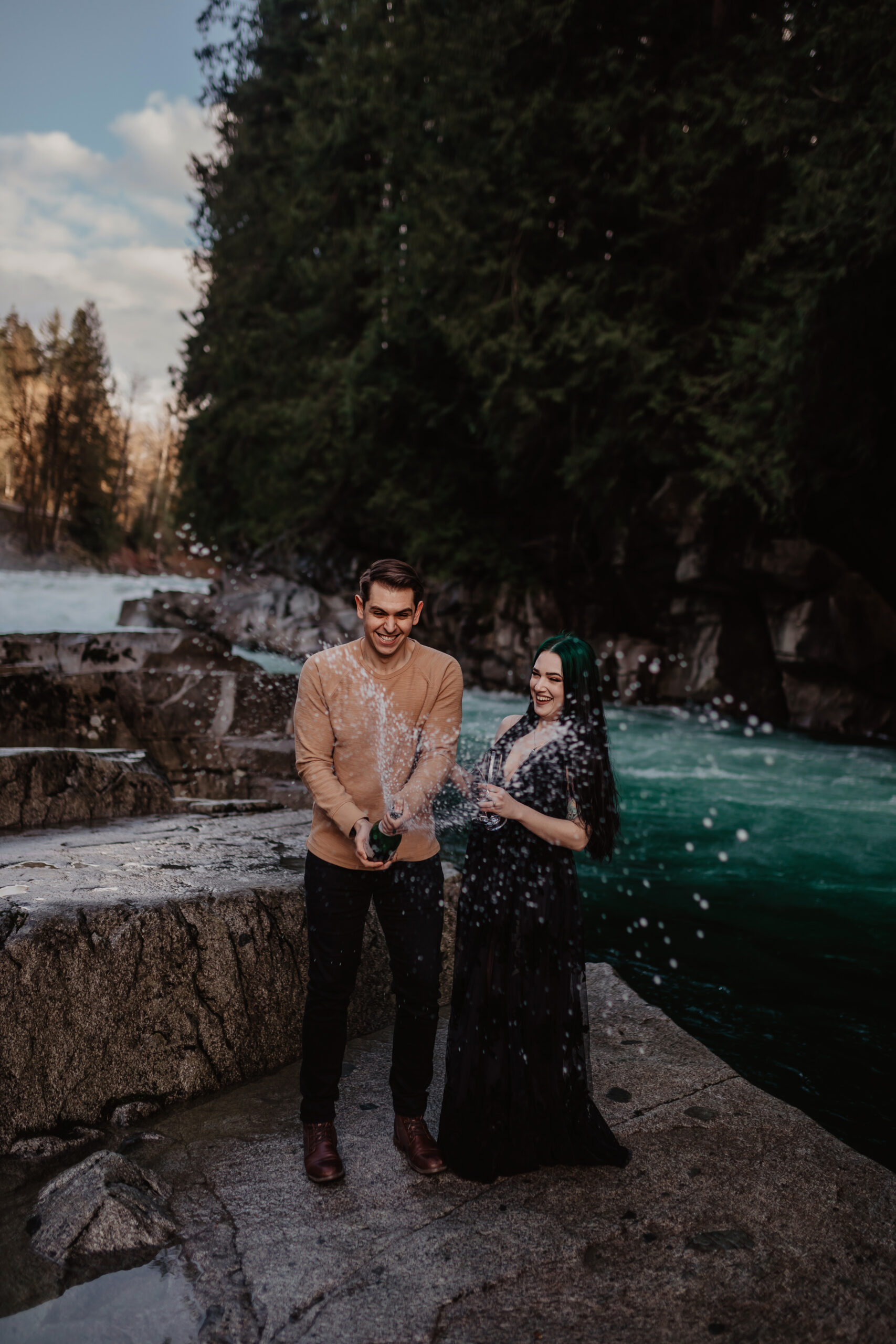 Couple popping champagne at Eagle Falls