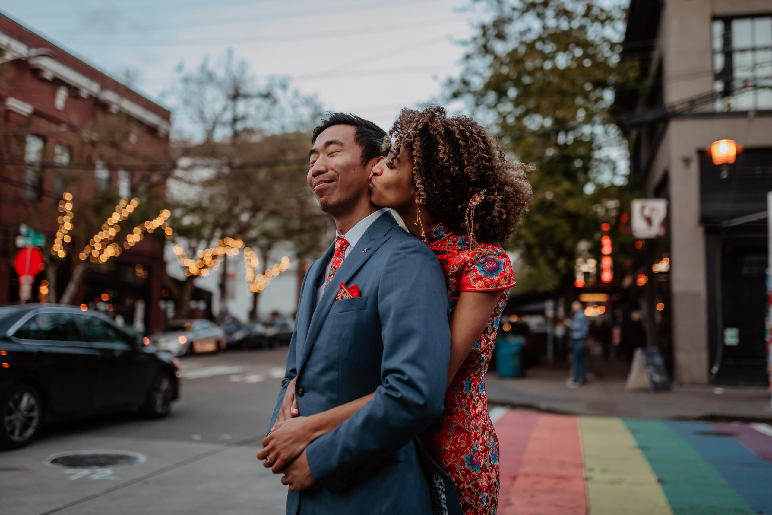 Couple in Chinese wedding attire cuddling on Capitol Hill