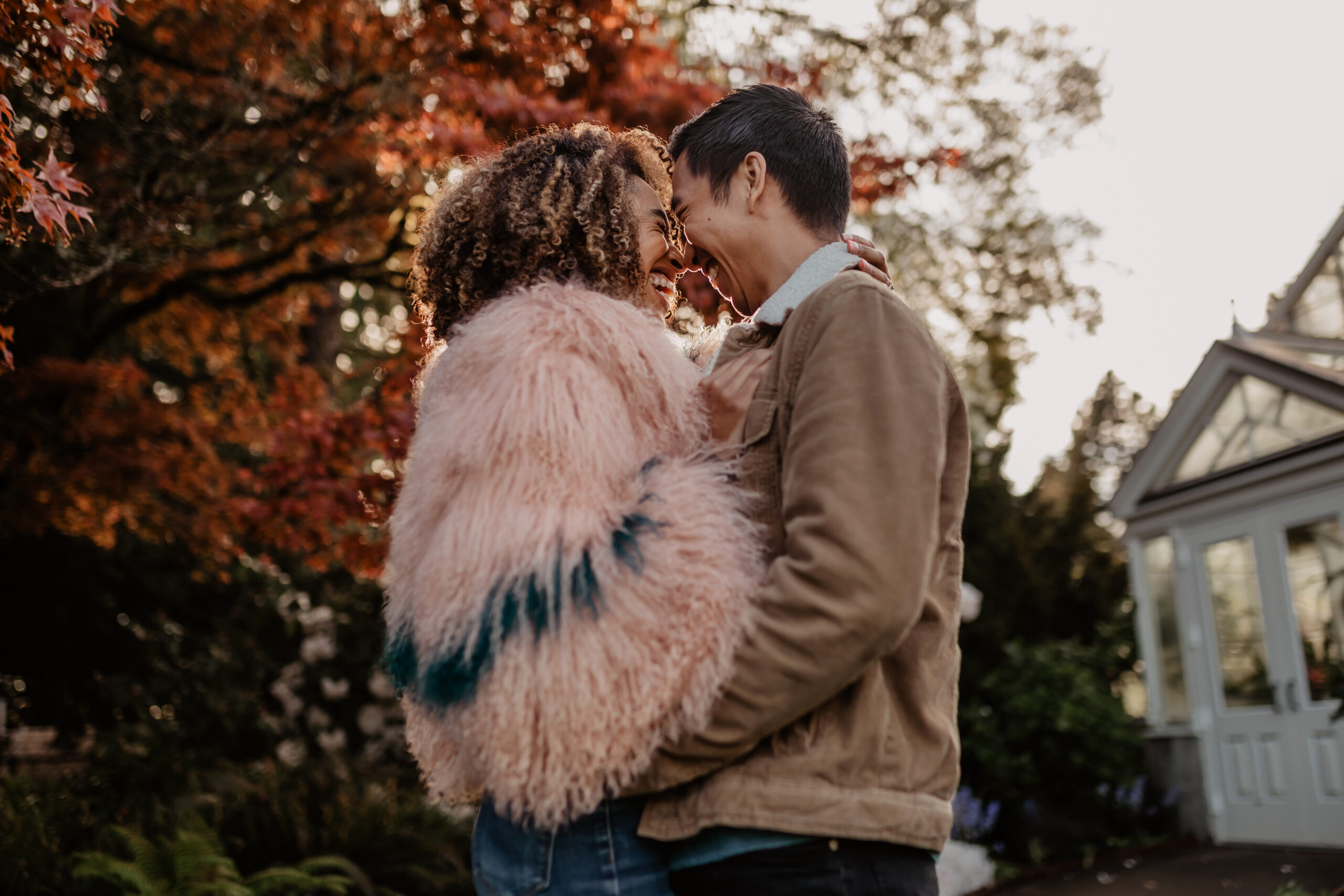 Couple embracing in a hug and laughing during engagement photos in Volunteer Park