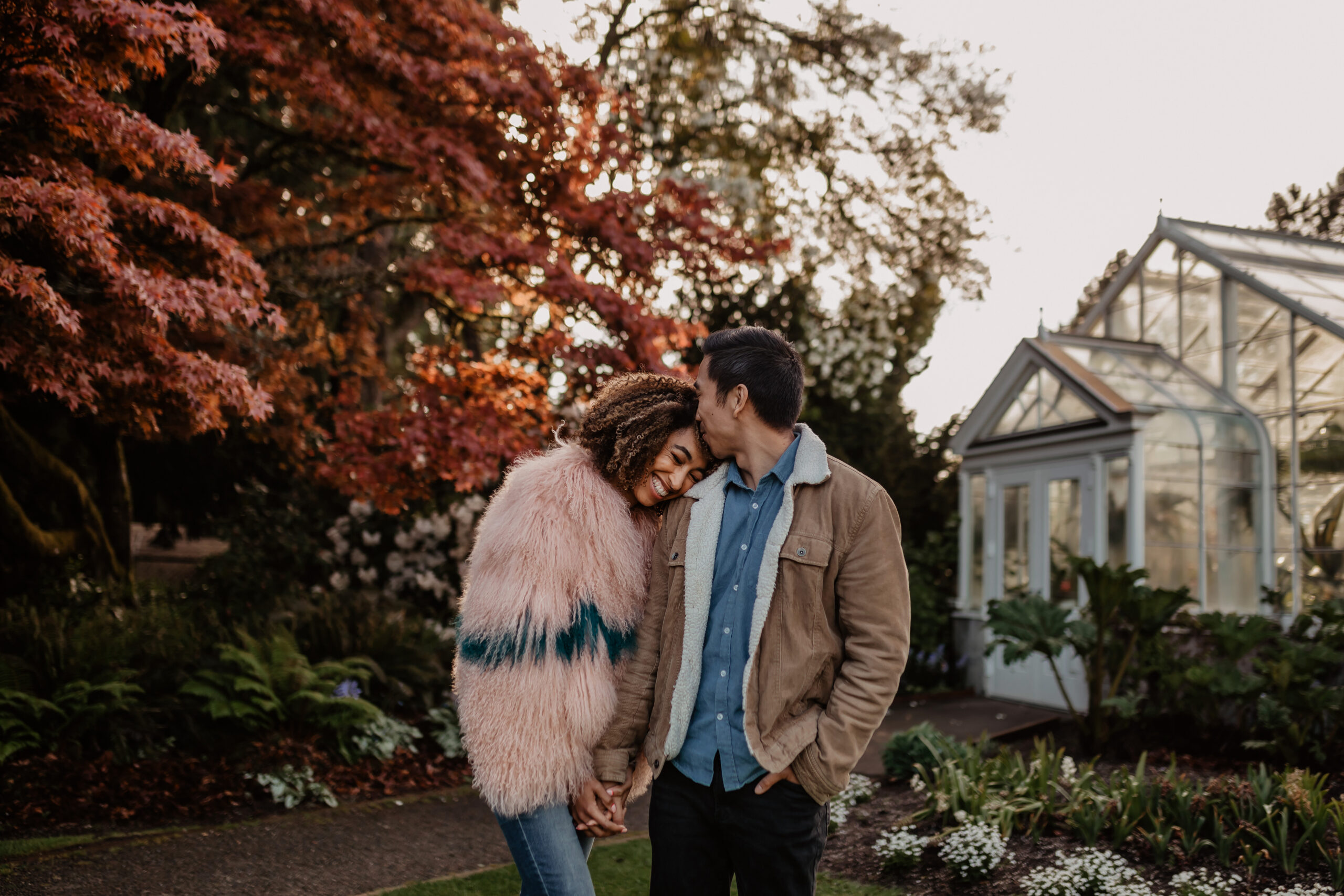 Couple cuddling up during engagement photos in Volunteer Park